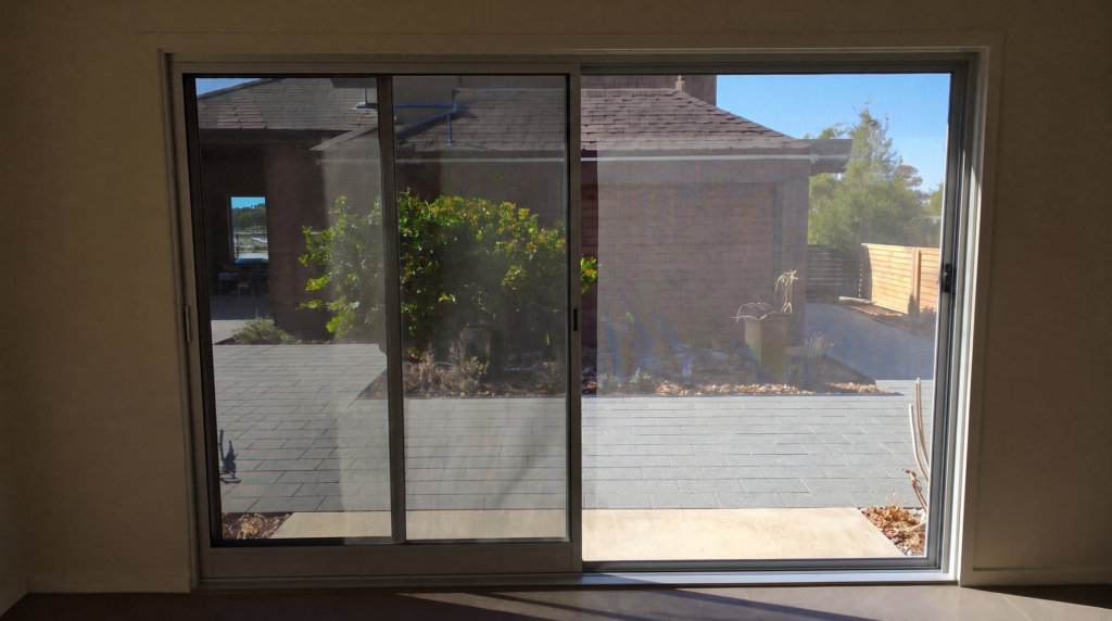 Sliding flyscreen door with new mesh after repair